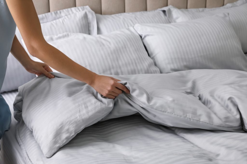 woman making a bed