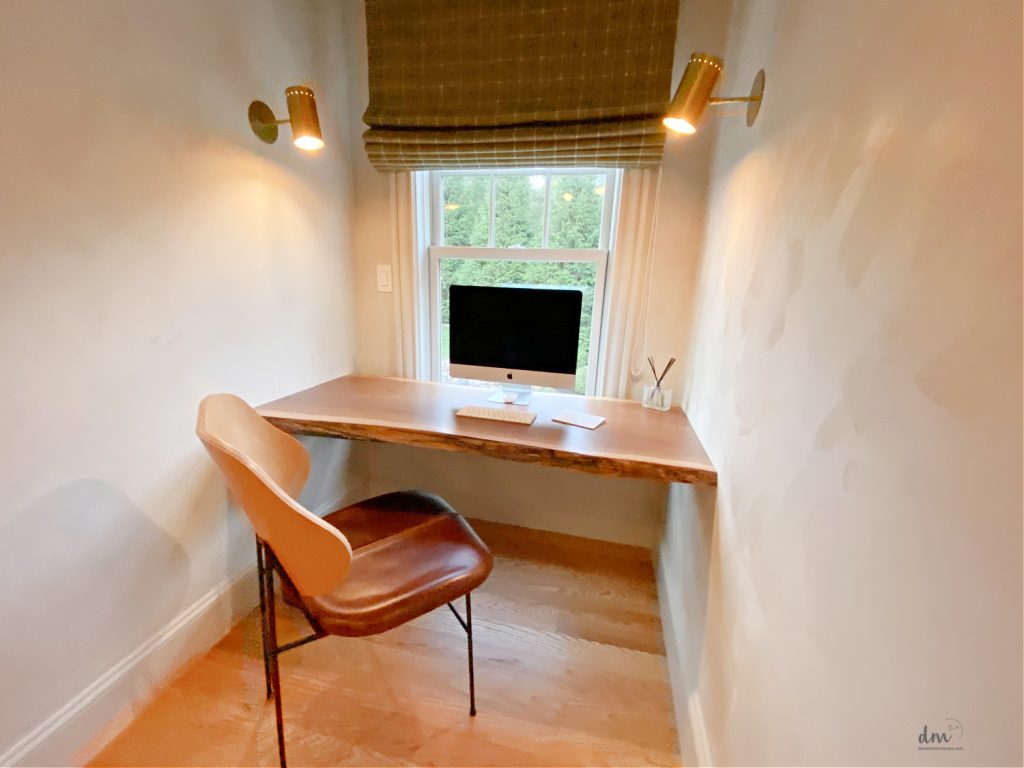 a cubby office next to a window