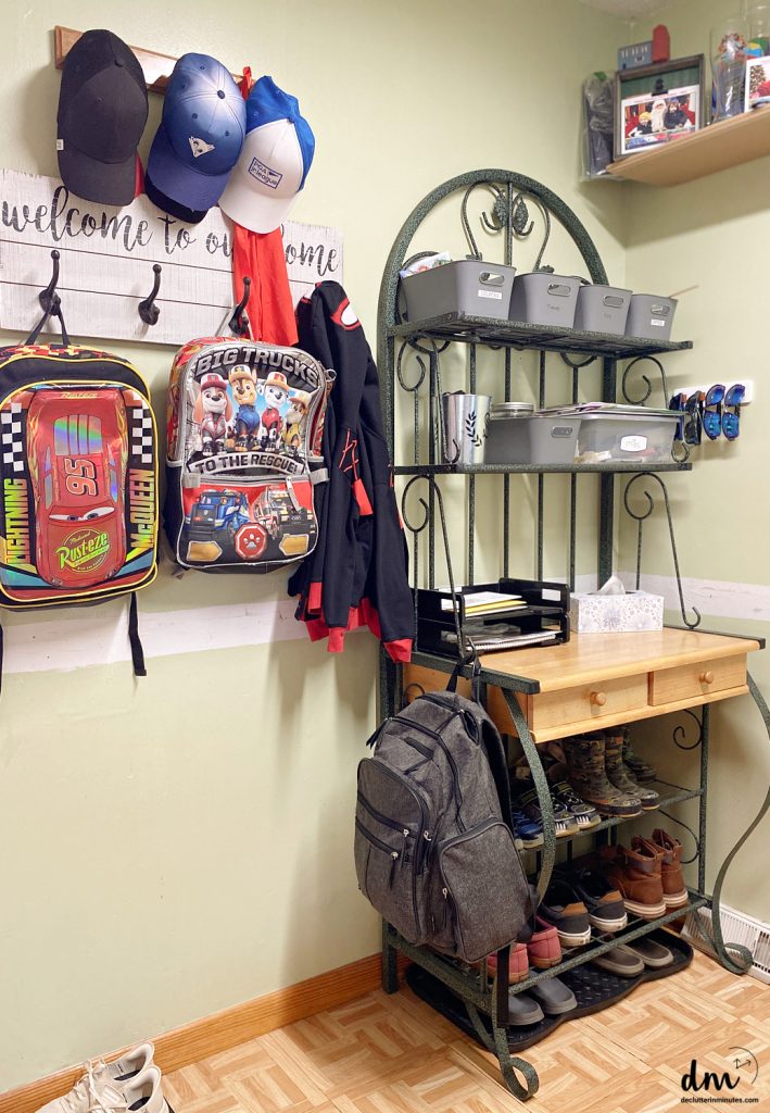 a home hub in a kitchen with bookbags on hooks, hats, and shoes