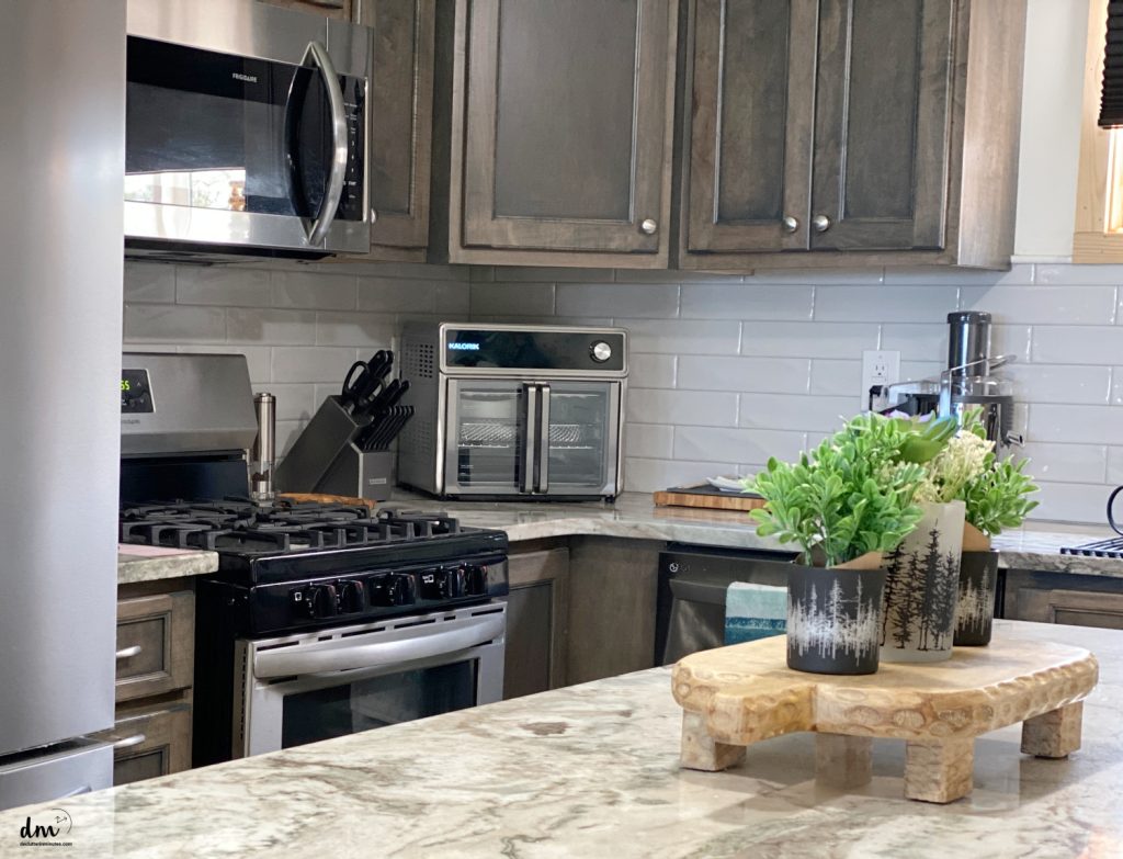 air fryer out on a kitchen counter next to a stove