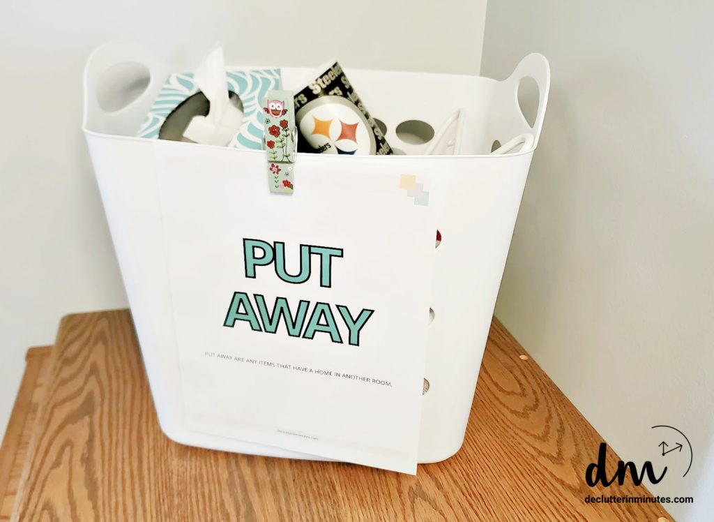 basket of random things with a put away sign on the front