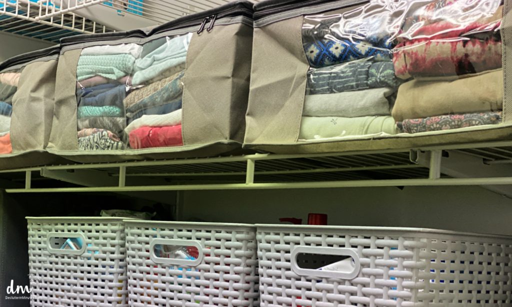 clothes storage in bags on a closet shelf