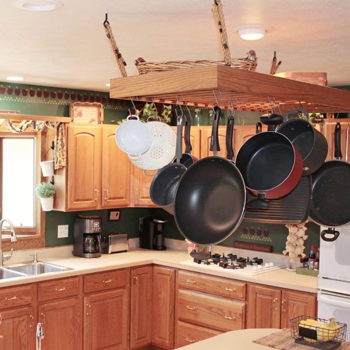 pots and pans hanging from a ceiling in a kitchen copy