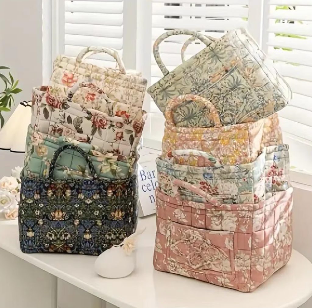 quilted bags stacked and sitting on a table