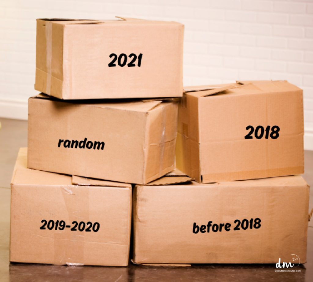 a collection of brown boxes filled with paperwork and dates written on the outside