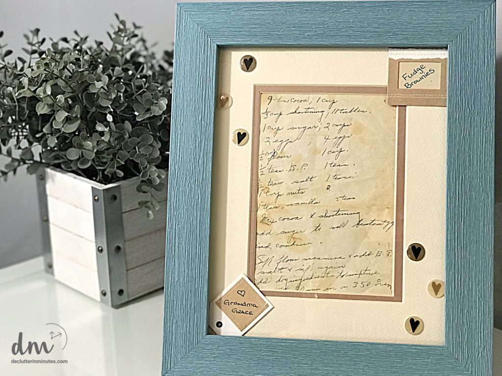a family recipe that has been framed next to a plant