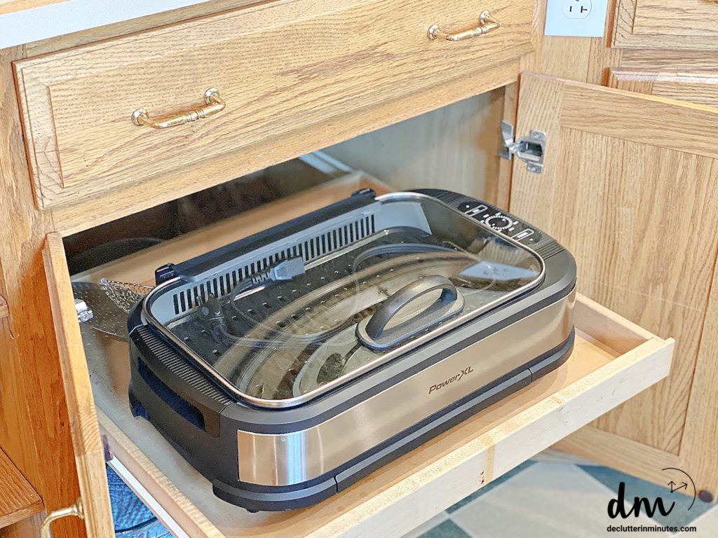 an indoor grill stored in a cabinet