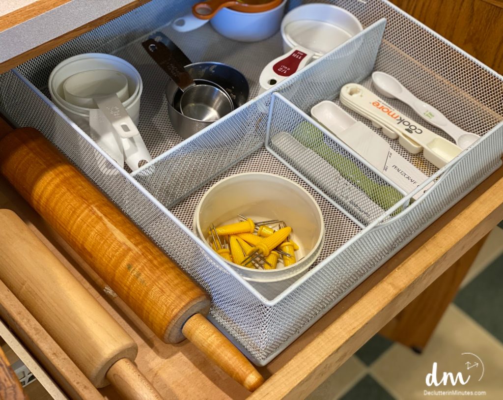 an organized drawer in a kitchen of measuring cups and spoons