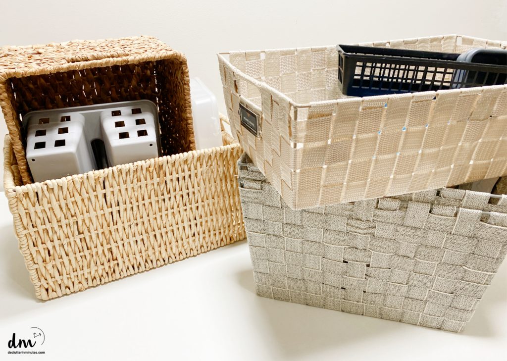 a pile of random baskets stacked up and inside of each other on a white table