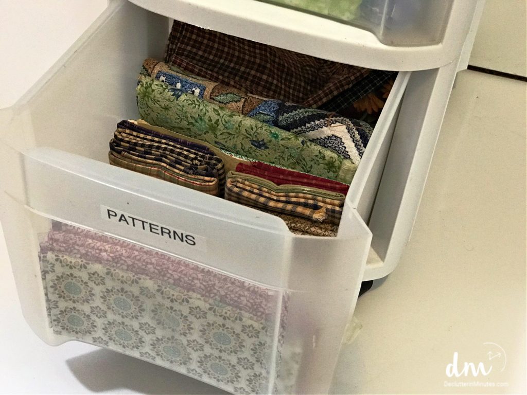 fabric in a plastic drawer in a craft room