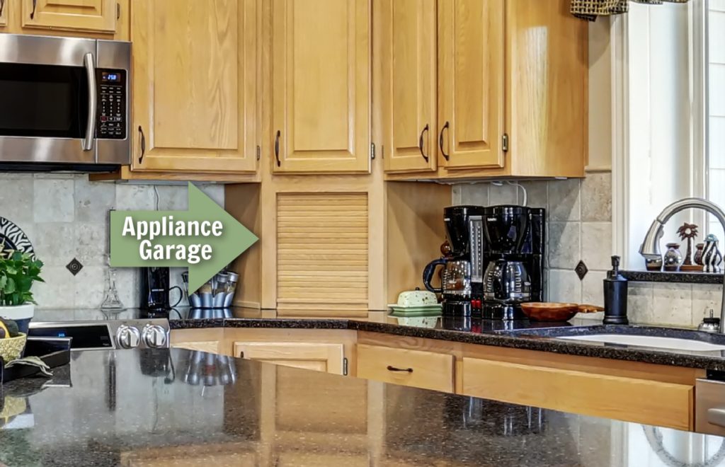 an appliance garage in a kitchen with a green arrow pointing to it