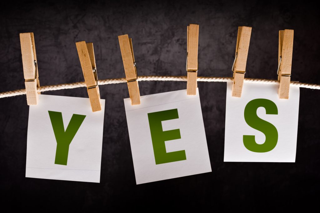 Yes words hung up with clothes pins on a string