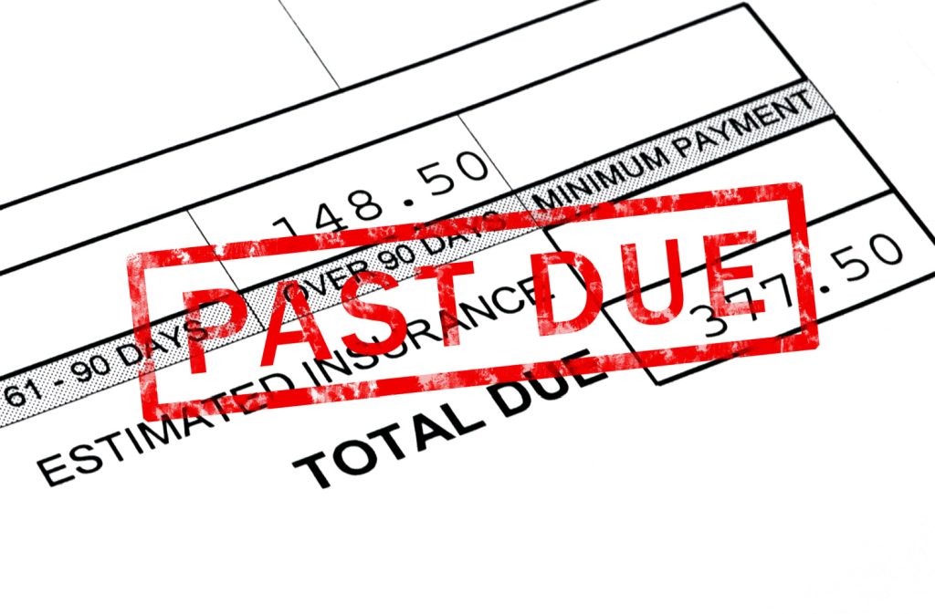 a bill with a past due stamp on top of it
