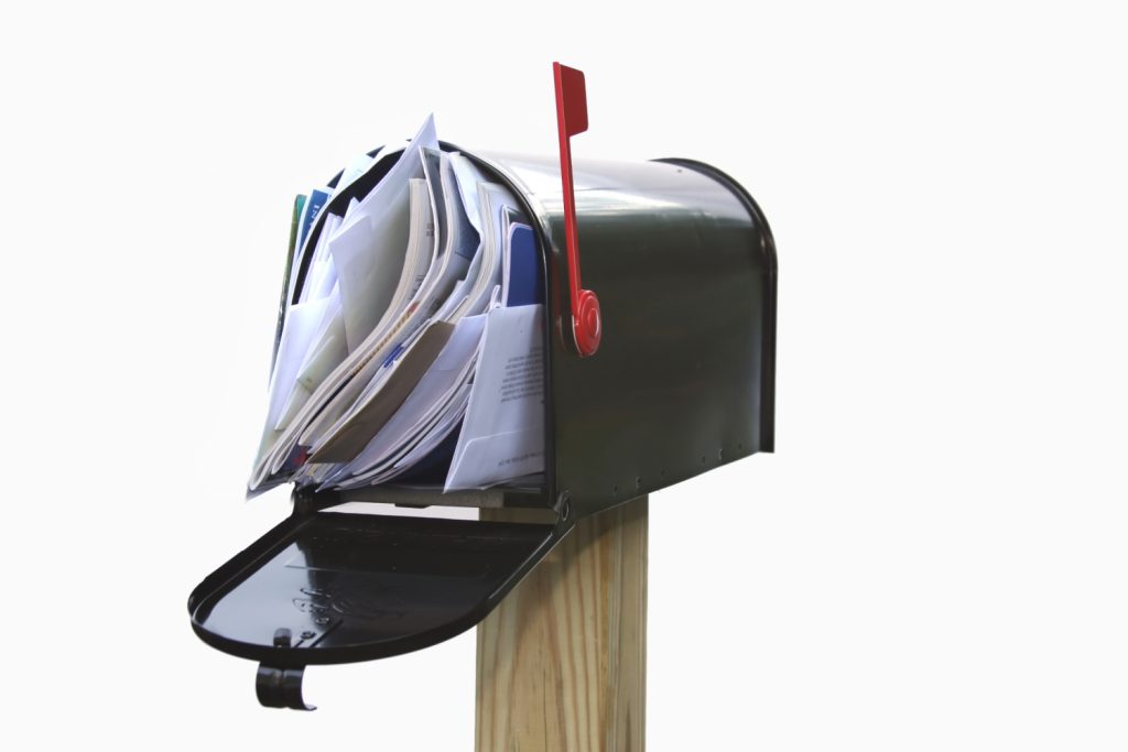 a-black-mail-box-with-mail-stuffed-inside