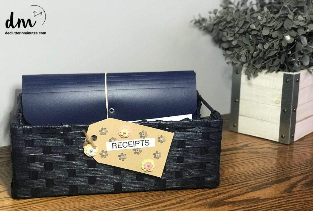 A navy blue accordion file labeled "RECEIPTS," neatly stored in a black woven basket 