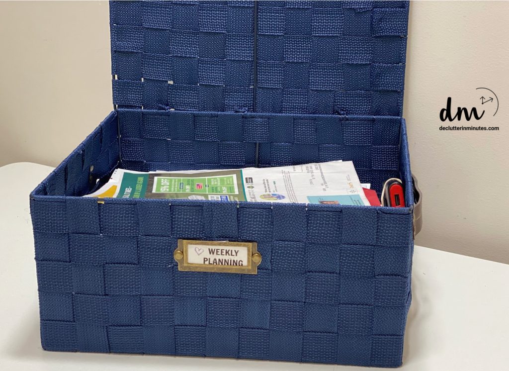 a blue basket full of mail labeled weekly planning 