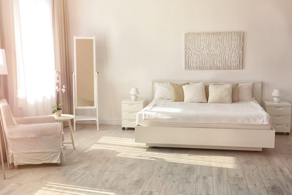 a white bedroom that is neat and free of clutter