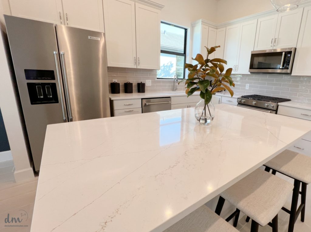 a white and grey kitchen that is neat and clutter-free 