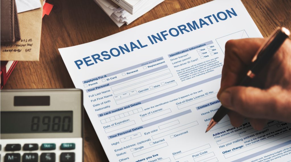 hand filling out a personal information paper 