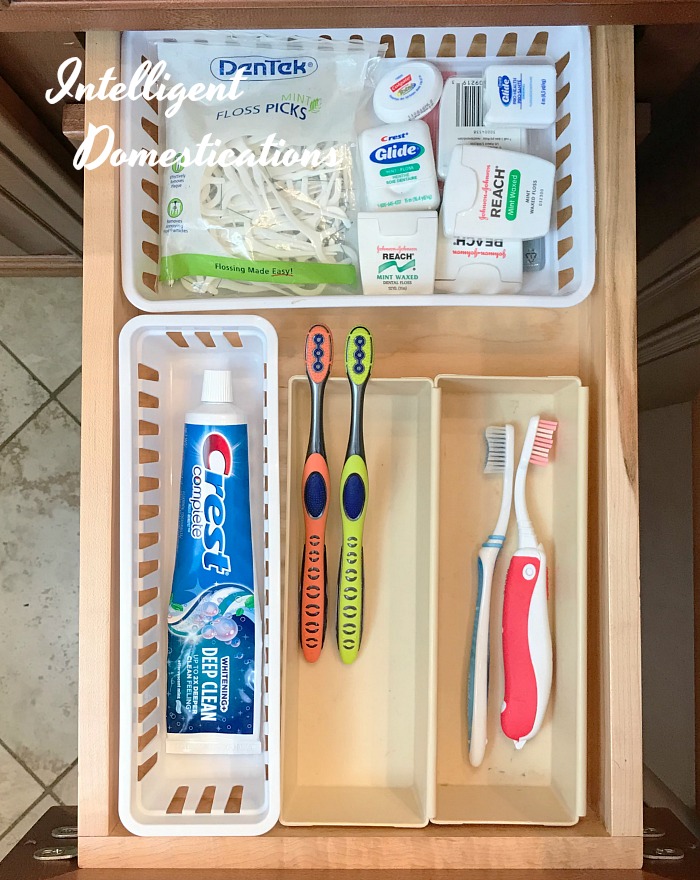 a drawer with different size baskets organizing toothbrush, toothpaste and floss