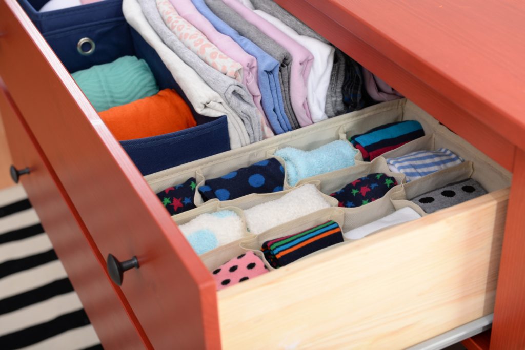 Folded clothes in chest of drawers closeup