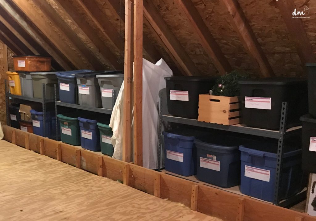 a shelving system filled with totes in an atttic