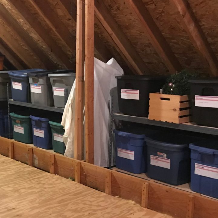 a shelving system filled with totes in an atttic