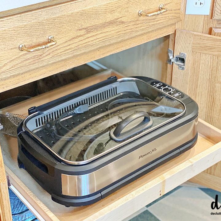 an indoor grill stored on a pull out drawer in a cabinet copy