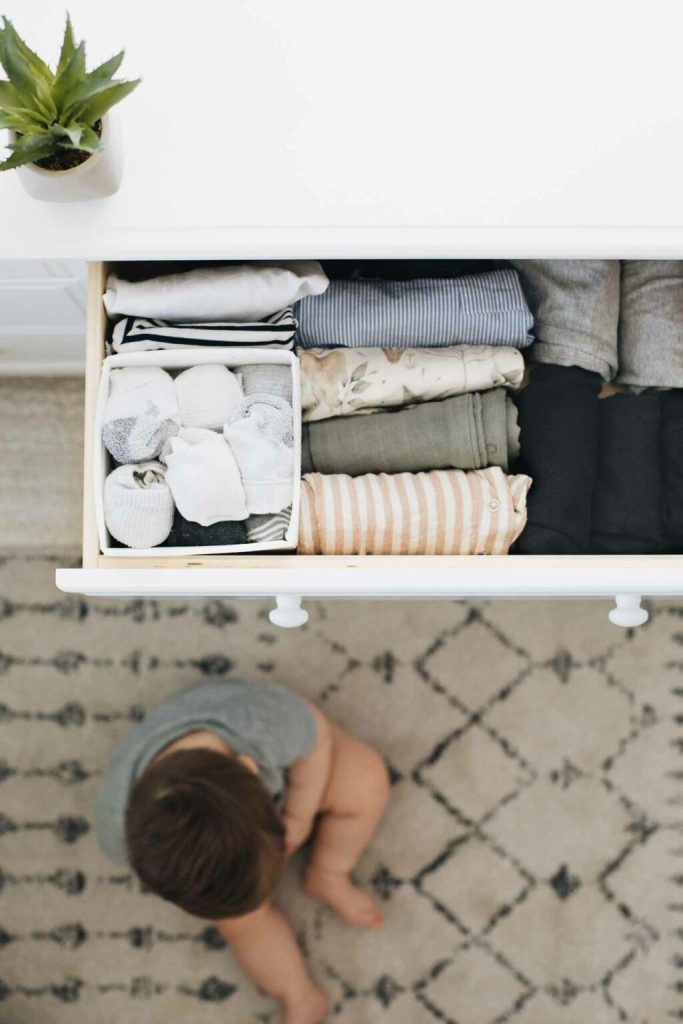 Image that shows a small container inside the corner of a drawer with socks in it.