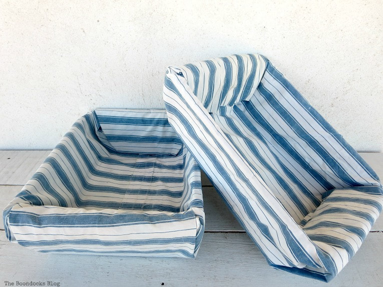 Two fabric-lined storage bins with blue and white stripes
