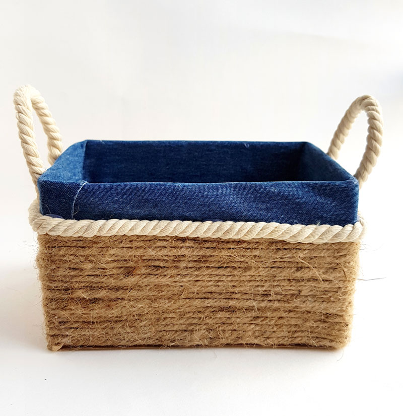 a box turned into a basket with handles using rope and cloth