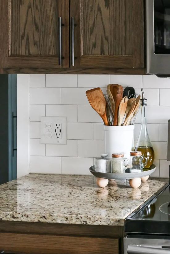 a DIY foot tray that holds spices, oil bottle and a jar with kitchen utensils. 