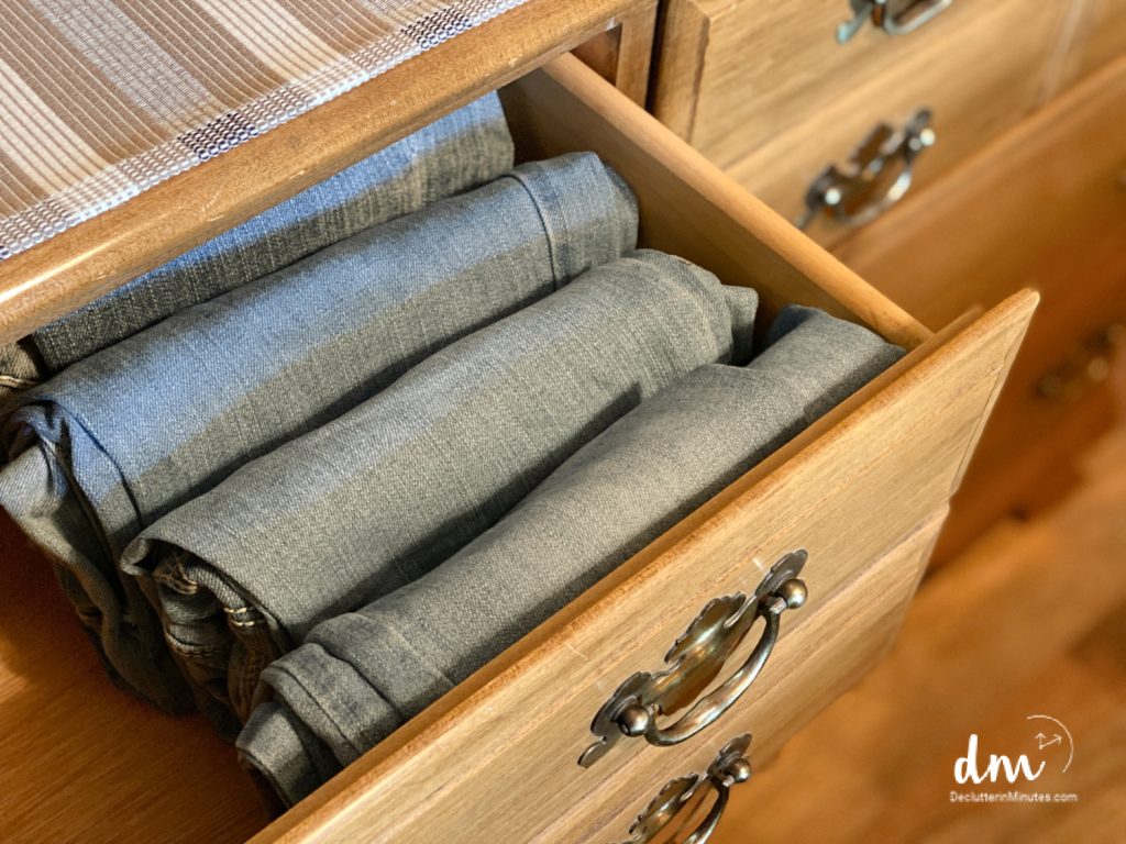 jeans folded vertically in an organized dresser drawer