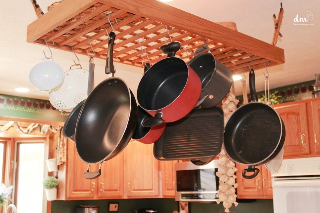 Image that shows a rack on the ceiling that holds pots. 