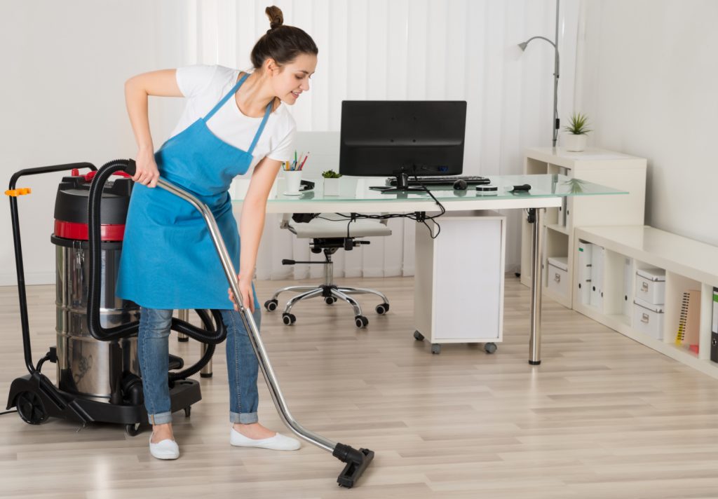 woman vacuuming home office floor