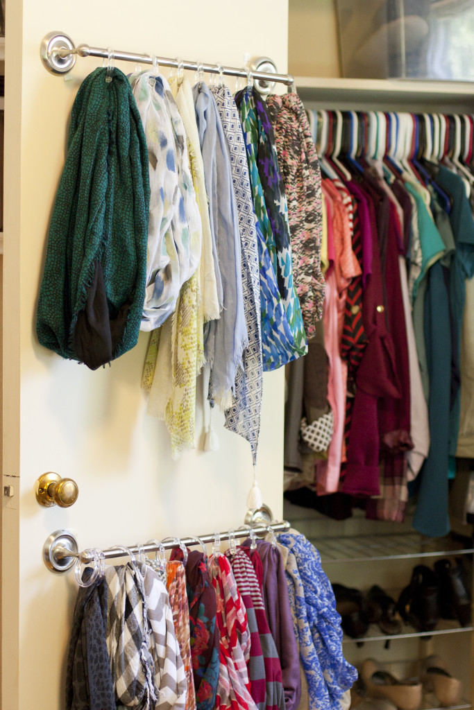 Image that shows a curtain rod hung on a door that holds scarves.