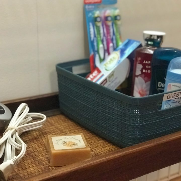 a basket in a guest bedroom with toiletries inside