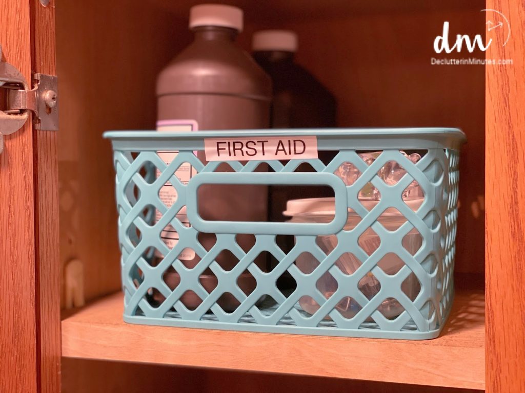 Image that shows a labeled plastic bin for first aid items. 