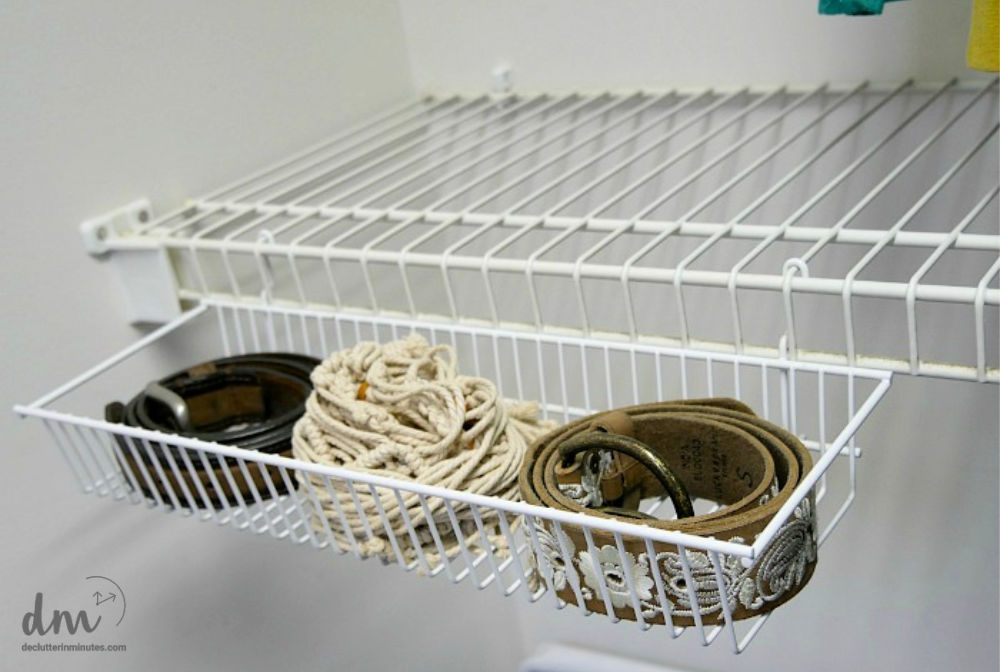 Image that shows a bin hooked to a shelf that hold belts.