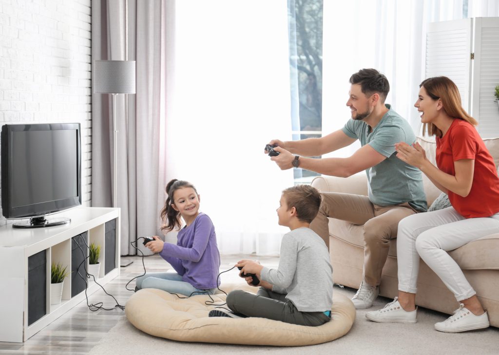 a family playing video games in a family room