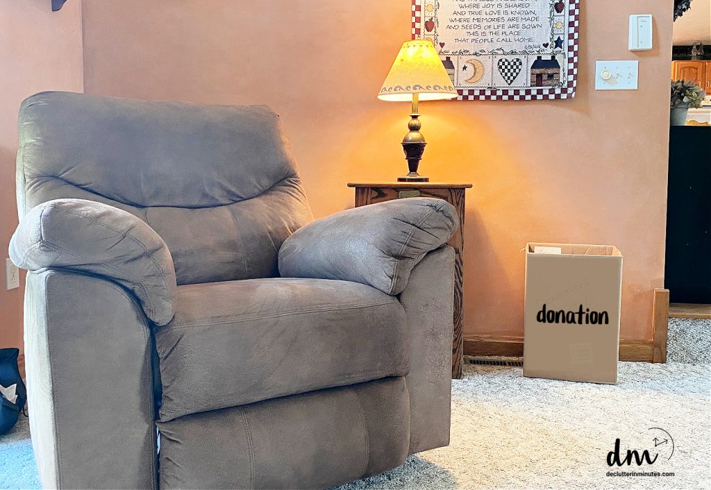 donation box next to a brown chair in the family room