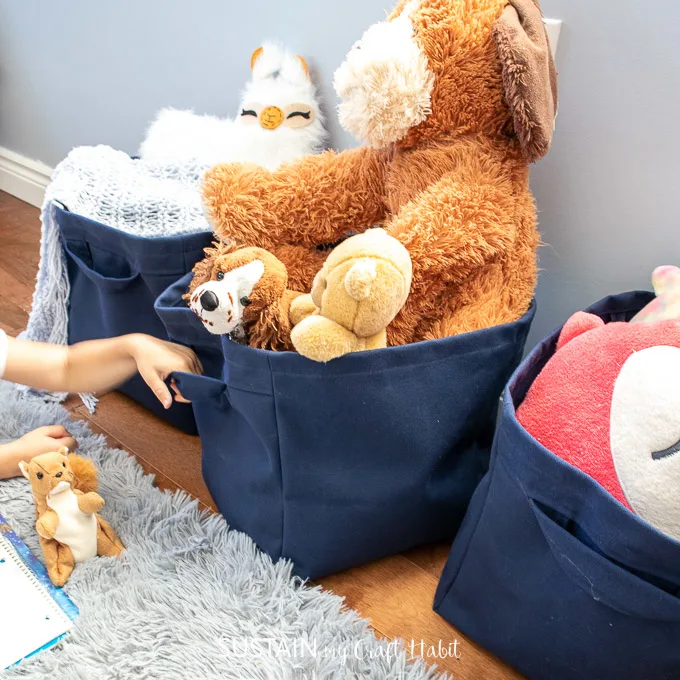 An image that shows DIY fabric baskets that hold stuff animals and toys. 