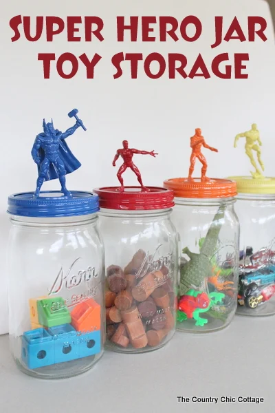 An image that shows mason jars that hold toys with superheroes on each lid. 