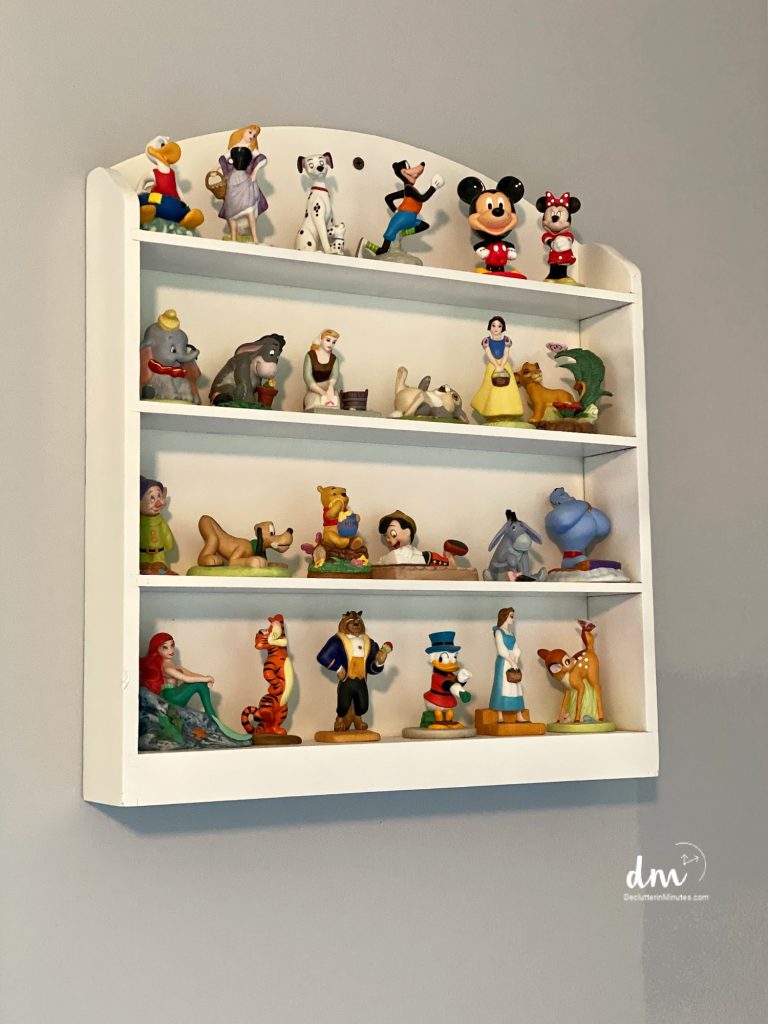 An image that shows a shelf with Disney figurines.
