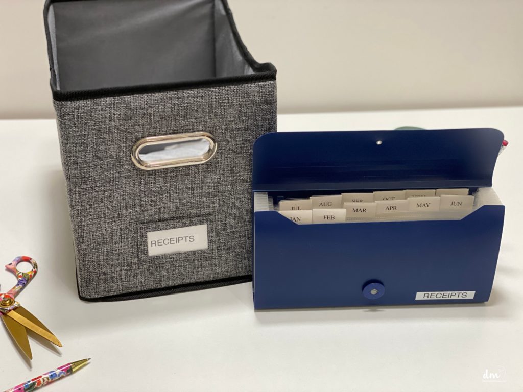 a basket labeled receipts with an accordion file