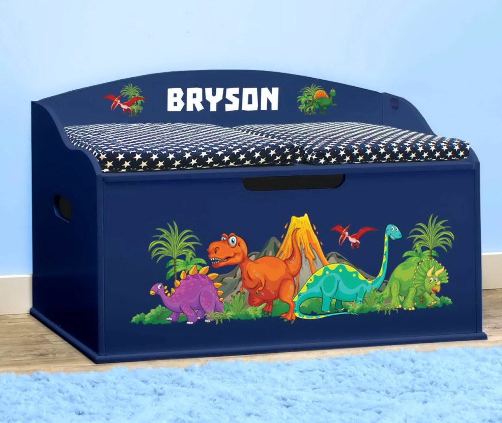 a custom made blue toy box with dinosaurs on the front and a cushion for sitting