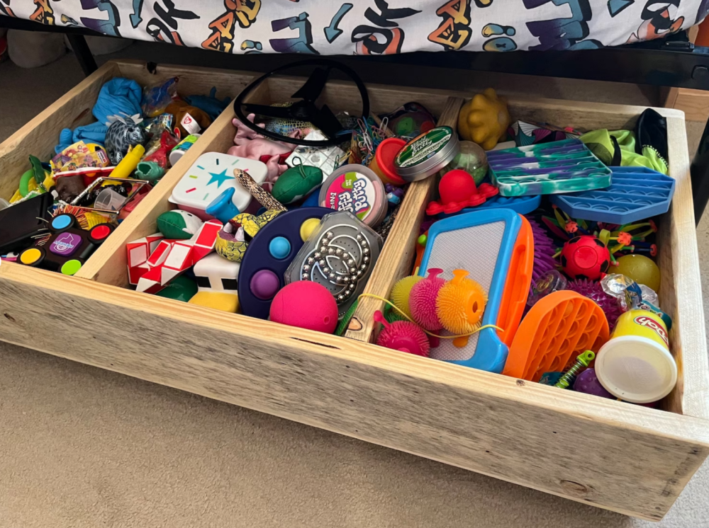 a handmade storage bin of toys under a childs bed 