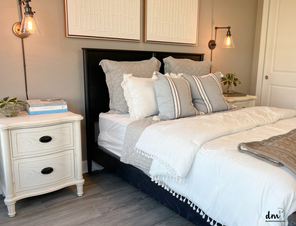 a neat and organized nightstand next to a bed