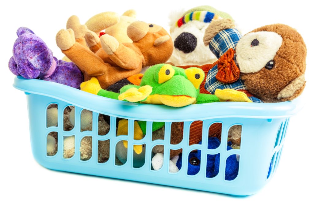 Soft toys in a plastic container isolated on white background.