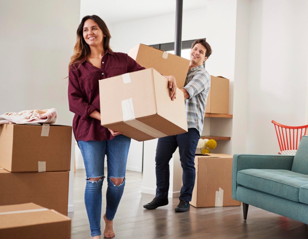 a couple taking boxes out of a home